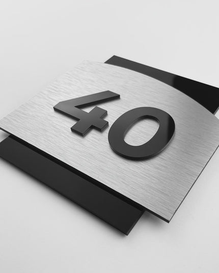 Flow Design modern door number sign by ALUMADESIGNCO featuring brushed silver aluminum base and acrylic numbers, elegant signage for hotels, offices, and residential interiors