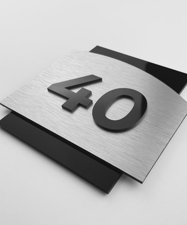 Flow Design modern door number sign by ALUMADESIGNCO featuring brushed silver aluminum base and acrylic numbers, elegant signage for hotels, offices, and residential interiors