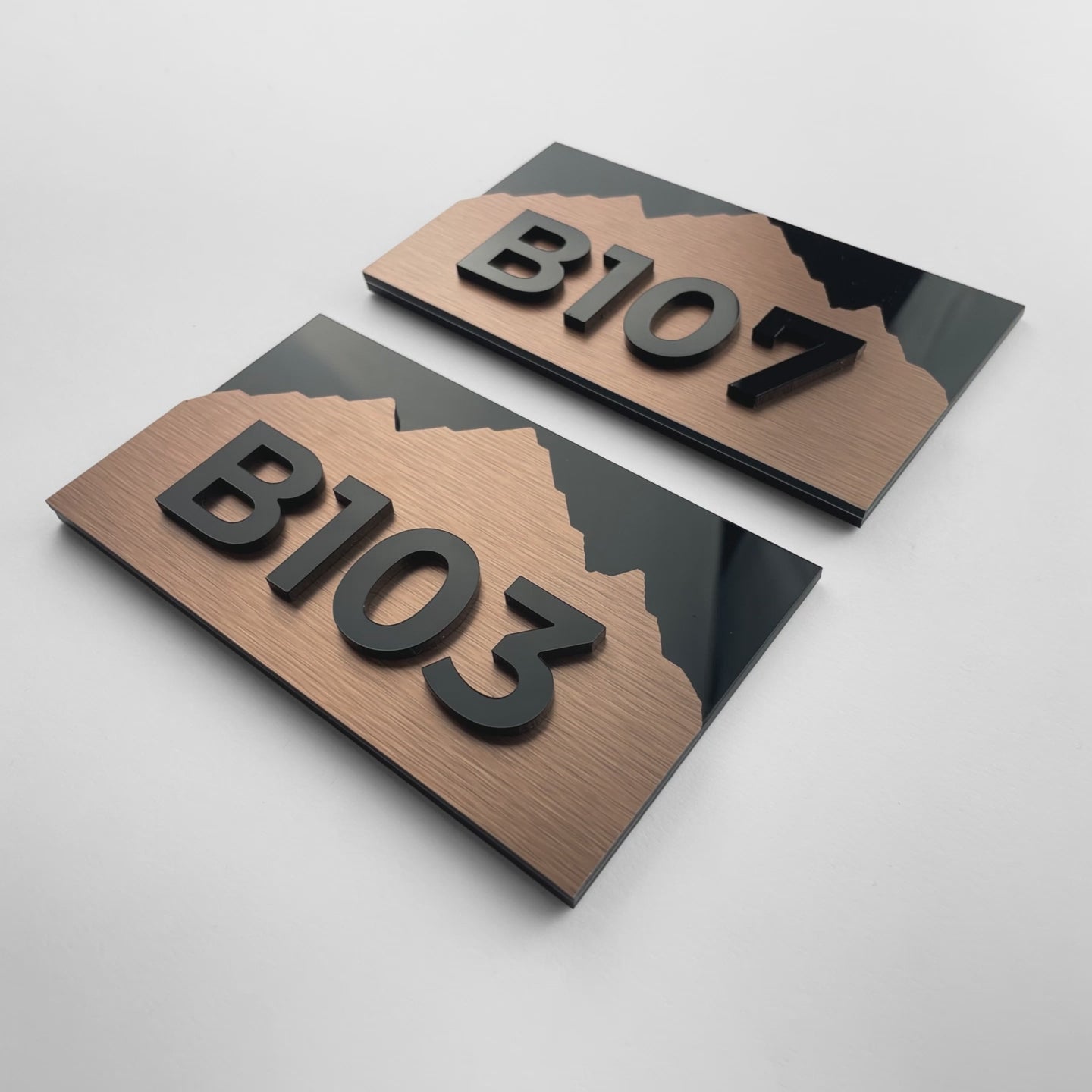 Custom brushed bronze hotel room number sign Alpine Design by ALUMADESIGNCO featuring metal plaque and acrylic numbers, elegant door signage for hotel corridors and interiors