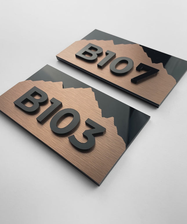 Custom brushed bronze hotel room number sign Alpine Design by ALUMADESIGNCO featuring metal plaque and acrylic numbers, elegant door signage for hotel corridors and interiors