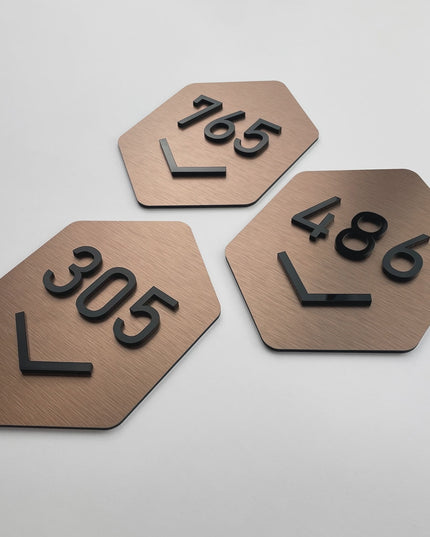 Premium Hexagon Design brushed BRONZE room number sign by ALUMADESIGNCO featuring acrylic numbers, modern door signage for hotels, apartments, and offices