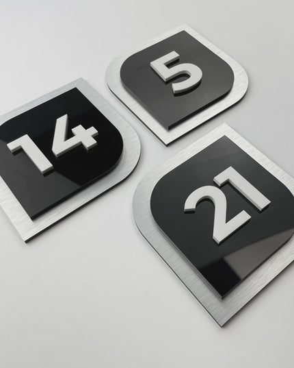 Modern 3D door number plate by ALUMADESIGNCO combining layered materials and acrylic numbers, stylish interior signage for hotels and apartments