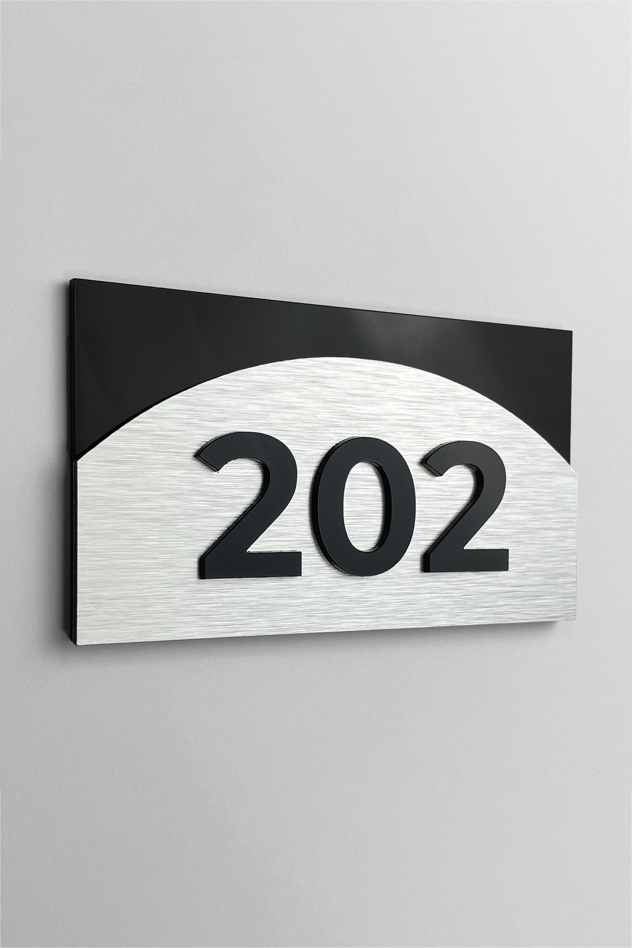 Custom 3D layered room number sign Flow Design by ALUMADESIGNCO featuring wood and acrylic layers, modern door plaque for hotel rooms and apartment interiors